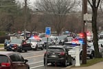 Emergency vehicles are parked outside the Abundant Life Christian School in Madison, Wis., where multiple injuries were reported following a shooting, Monday, Dec. 16, 2024. (AP Photo/Scott Bauer)