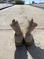 Combat boots stand in front of the memorial.