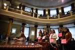 Proponents of the housing ordinance proposed by the Portland City Council hold up a sign in support during testimony on April 4, 2019.