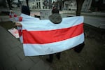 Several people lit candles and posted pictures of victims of political persecution in front of the Belarusian embassy on Jan. 26, 2025. Nearly two thousand people are being held on political charges in Belarus and nearly 9,000 cases of political persecution have been documented in 2024 alone.