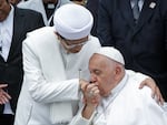 Pope Francis (right) kisses the right hand of the Grand Imam of Istiqlal Mosque Nasaruddin Umar after an interreligious meeting with faith leaders at the Istiqlal Mosque in Jakarta, Thursday.