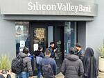 A worker tells people that the Silicon Valley Bank (SVB) headquarters in Santa Clara, Calif., is closed on March 10, 2023. Federal regulators took extraordinary measures on Sunday to backstop all deposits at SVB after the lender's spectacular collapse.