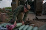 Israeli soldiers prepare and fire mortars from inside Israel into Gaza, backing up troops near the Maghazi refugee camp on Jan. 22.