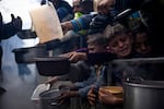 Palestinians line up for a meal in Rafah, Gaza Strip, Feb. 16.