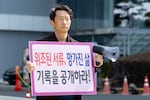 Jonggeun Song, born in 1979 and adopted in the Netherlands at age 4, stages a one-person protest in front of the Korea Child Rights Protection Agency in Seoul, South Korea, on April 1. He holds a sign that reads, ''Forged Documents, Broken Lives, Release the Records.'' He calls for the disclosure of overseas adoption records and an end to international adoptions.