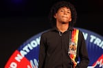 A model walks down the runway at the pre-gala fashion show during the 2024 UNITY Conference on July 2. He is wearing a ribbon shirt designed by one of the other Native youth attending this year’s conference.