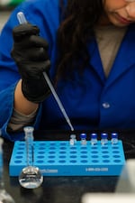 Formulation chemist Jocelyn Chace pipettes samples for high-performance liquid chromatography machines, which were used to test a Voupre product obtained by NPR, at Founders Science Group’s laboratory in Taunton, Massachusetts.