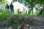 Kansala, Guinea-Bissau (September 24, 2024) - Residents of nearby Durabali stand on the Kansala site, shows the area where the city's gunpowder house was located. Griots had for generations sung that Kansala ended by blowing up the gunpowder house when it was under attack from a neighboring kingdom. The archeologicl dig's findings of remnants and deposits confirmed this is a strong possibility.