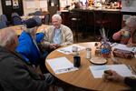 Pearl Harbor survivor and World War II Navy veteran David Russell, 101, center, talks with Denise Emery, center left, and other veterans while eating breakfast at the American Legion Post 10 on Monday, Nov. 22, 2021, in Albany, Ore.