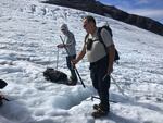 Max Hannah (left) and Oliver Grah measure the ablation (thinning) of Sholes Glacier on Mount Baker on Sept. 23, 2021.