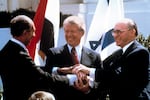 Sadat (from left), Carter and Begin clasp hands outside the White House on March 26, 1979, as they completed signing of the peace treaty between Egypt and Israel in Washington. Carter's efforts were the first major push by a modern U.S. president to foster peace in the Middle East.