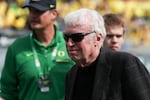 Nike founder Phil Knight walks on the field before a football game between Colorado and Oregon, Saturday, Sept. 23, 2023, in Eugene, Ore. While lawmakers discussed new campaign finance limits, Knight quietly gave $2 million to a political action committee that tries to elect Republicans to the Oregon Legislature.