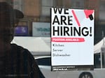 A "We Are Hiring" sign is posted in front of a restaurant in Los Angeles on Aug. 17, 2022. The labor market remains resilient, raising hopes that any recession would be mild.