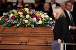 Amy Carter, daughter of former President Jimmy Carter and Rosalynn Carter, touches the casket after speaking at her mother's tribute service at Glenn Memorial United Methodist Church at Emory University on November 28, 2023 in Atlanta, Georgia.