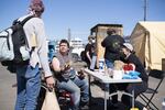 Chris Drake, center, checks into the LGBTQ outdoor emergency shelter on April 16, 2020, in Southeast Portland. Drake is autistic and says the coronavirus has disrupted his daily routines and worsened his mental health.