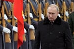 Russian President Vladimir Putin attends a wreath-laying ceremony at the Tomb of the Unknown Soldier, near the Kremlin Wall during the national celebrations of the 'Defender of the Fatherland Day' in Moscow, Russia, Wednesday, Feb. 23, 2022. The Defenders of the Fatherland Day, celebrated in Russia on Feb. 23, honors the nation's military and is a nationwide holiday.