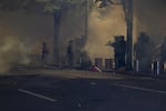 Federal law enforcement officers use tear gas to disperse protesters during demonstrate against racism and police violence in front of the Mark O. Hatfield federal courthouse on July 12, 2020. Earlier in the night, federal law enforcement officers shot a demonstrator in the head with a less lethal impact munition, causing severe injury.