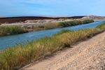 In parts of the south-eastern most California border with Mexico has two fences and a canal, across it.