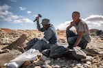 An ilegal diamond miner breaks up rocks at the Nuttabooi mine near Kleinzee, South Africa.