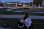 Mourners gather outside Silver Rail Elementary School for a vigil on Oct. 16, 2026, Bend, Ore.