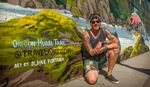 Artist Blaine Fontana poses in front of The Dalles mural located at the Mount Hood Railroad.