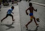 Children kick a ball around during a power outage in Havana, Cuba, on Wednesday.