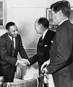 In this Dec. 17, 1962 file photo, Ambassador Adlai Stevenson, the U.S. delegate to the United Nations, shakes hands with Martin Luther King Jr., president of the Southern Christian Leadership Conference, Atlanta, Ga., at the White House in Washington with President John F. Kennedy at right. The meeting occurred as Kennedy met with members of the American Negro Leadership Conference on Africa. Historians generally agree that Kennedy's phone call to Coretta Scott King expressing concern over her husband's arrest in October 1960, and Robert Kennedy's work behind the scenes to get King released, helped JFK win the White House that fall. King himself, while appreciative, wasn't as quick to credit the Kennedys alone with getting him out of jail, according to a previously unreleased portion of the interview with the civil rights leader days after Kennedy's election. (AP Photo, File)