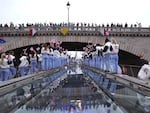 Spectators cheer as Athletes of Team Great Britain pass under a bridge during the opening ceremony of the Olympic Games Paris 2024 on July 26.