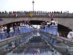 Spectators cheer as Athletes of Team Great Britain pass under a bridge during the opening ceremony of the Olympic Games Paris 2024 on July 26.