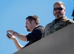Conservative influencer Nick Sorter, left, takes images from atop the U.S. Immigration and Customs Enforcement (ICE) facility on Oct. 7, 2025, during a visit by U.S. Homeland Security Secretary Kristi Noem.