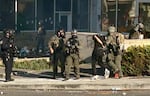 Federal officers arrest a protester outside the Portland ICE facility. Earlier on, a small group of demonstrators broke through the front door to the building.