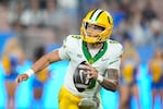 Oregon quarterback Dillon Gabriel (8) rolls out uring the second half of an NCAA college football game against UCLA Saturday, Sept. 28, 2024, in Pasadena, Calif.