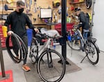 Mechanics at The eBike Store, Mark Winningkoff and service manager Jefferson Hunt, work at the shop on Jan. 13, 2025 in Portland, Ore. Electric bikes are among the imports that would be impacted by tariffs proposed by President Trump. Sales are up at The eBike Store thanks in part to customers purchasing e-bikes before potential tariffs can raise prices.