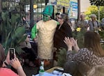 Betsy Johnson poses with Charles Maes, who is dressed like a stalk of asparagus. Maes' Milwaukie restaurant, Casa de Tamales, hosted an event for Johnson on July 7, 2022.