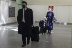 Air China cabin crew wearing face masks walk out of the international terminal at the San Francisco International Airport in Millbrae, California, United States on January 31, 2020.