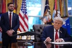 Vice President Vance watches as President Trump signs an executive order in the Oval Office.