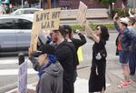 A small group of protesters gather in downtown Beaverton, Ore., on June 22, 2025, to protest against the recent U.S. bombings of nuclear sites in Iran.