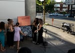 Members of Jason Washington's family help to unveil a mockup of an "accountability marker" marking the details and location of Washington's death on Thursday, June 29, 2023.