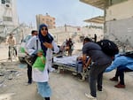 Palestinians evacuate Kamal Adwan hospital following an Israeli strike, amid the ongoing conflict between Israel and the Palestinian Islamist group Hamas, in Beit Lahia in the northern Gaza Strip, on May 21. 