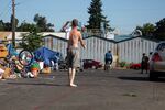FILE: A homeless resident at a camp near downtown Vancouver walks the street in the morning of Aug. 16, 2021. 