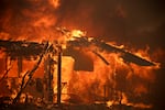 Flames engulf a structure during the Mountain Fire, Wednesday, Nov. 6, 2024, near Camarillo, Calif.