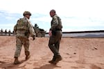 U.S. Army Lt. Col. Travis Stellfox, left, battalion commander of the 212 Infantry, talks with Michael Layton, acting patrol agent in charge of the U.S. Border Patrol Douglas Station, as the two walk near the US-Mexico border, as part of Joint Task Force Southern Border, Thursday, April 3, 2025, in Douglas, Ariz. (AP Photo/Ross D. Franklin)