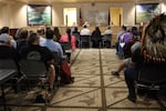 A room full of people sit in chairs at a Department of Fish and Wildlife meeting.