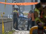 Emergency personnel transport the body of a victim at the scene of a fire at a lithium battery factory owned by South Korean battery maker Aricell in Hwaseong on June 24.