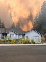 Sadie Rison, of Medical Lake, snapped this photo of her home and the Gray Fire on her way out of her neighborhood. Her home later burned down.