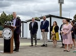 Portland politicians, with Mayor Ted Wheeler at the podium, address media during a July 17, 2023 event previewing the first large-scale alternative shelter at the Clinton Triangle in Southeast Portland. The site will offer temporary shelter to up to 200 people experiencing homelessness.