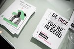 Programs for the Be Nice (White) You're In Bend exhibit on display at Scalehouse in Bend, Ore., on Aug. 6, 2021.