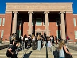 Students gather outside Grant High School in Portland on Wednesday, Aug. 28, 2024. Students have to check their Yondr cellphone restriction pouches before entering the building, which is new this year.