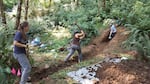 Portland State University researchers Alexis Judy (left), Lana Jewell, and Alison Horst (right) hand excavating a trench across the Gales Creek fault.