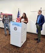 Grants Pass Housing and Neighborhood Specialist Amber Neeck speaks at a press conference in the city on July 18, 2024. From left to right, Doug Walker, residential developer and chair of the city's Housing Advisory Committee, and U.S. Senator Ron Wyden.